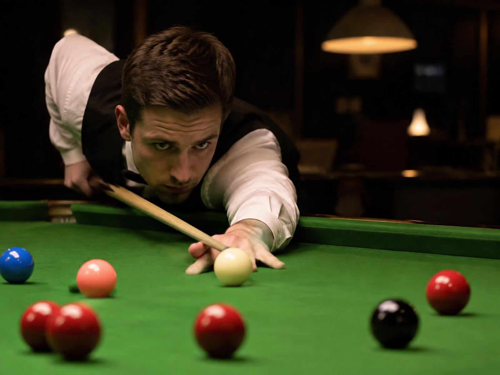 Snooker player taking a shot